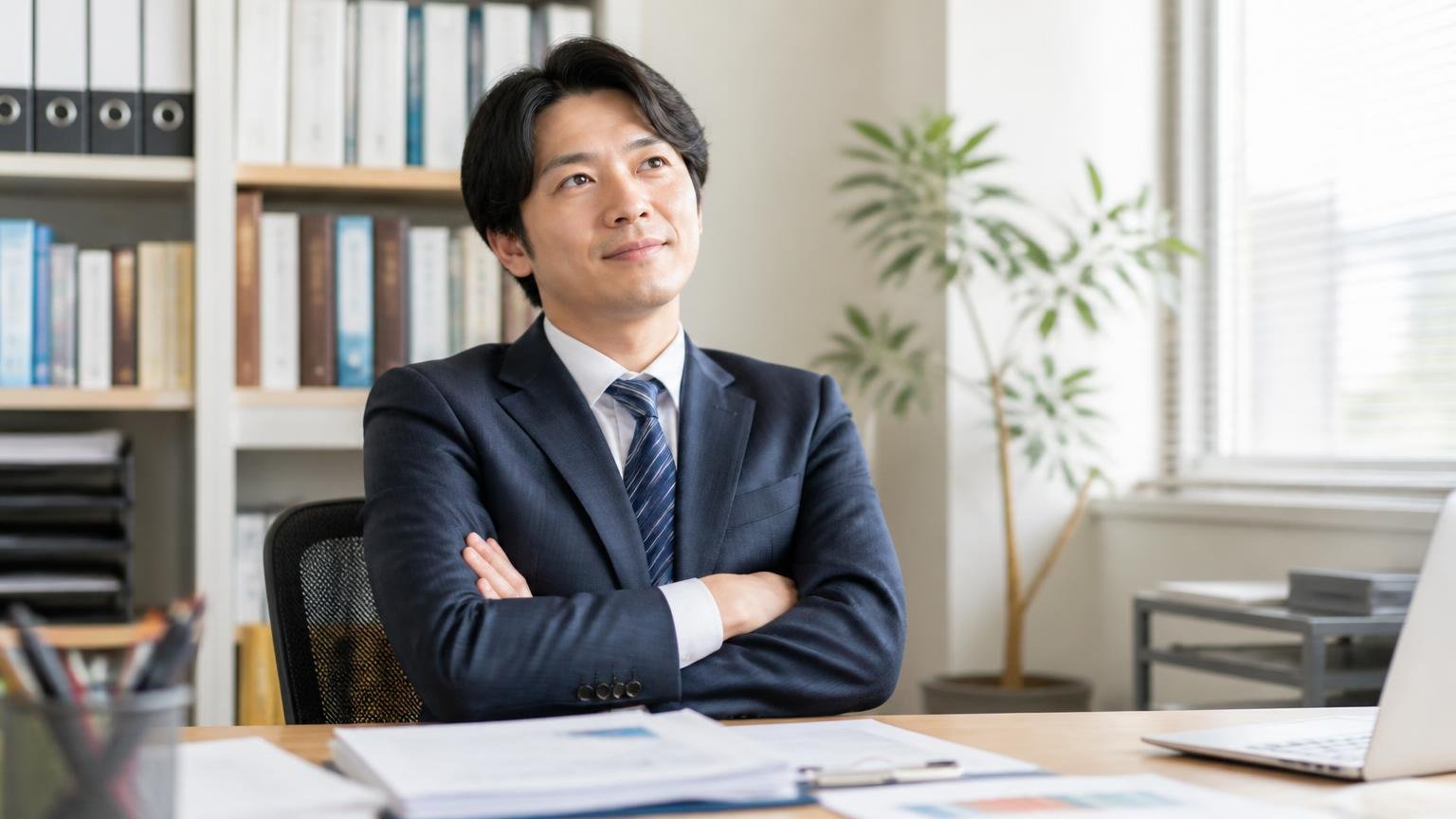 判定の結論。事務所の机で書類を前に、腕を組んで一点を見つめる男性の表情が晴れていく