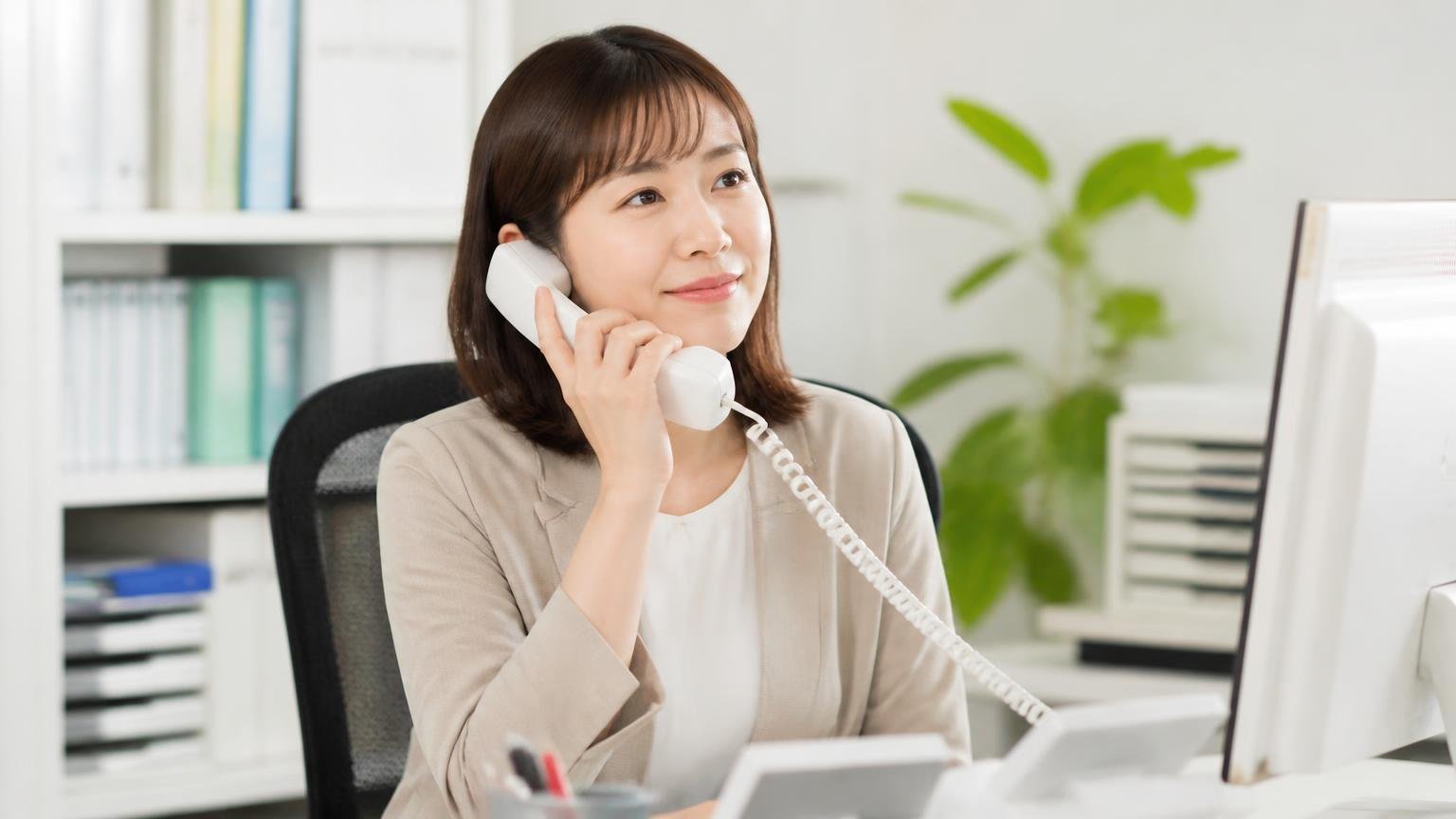 営業電話が不安な人がやっておくこと・事務所で電話を手に取る女性1人がほっとした表情